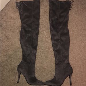 Thigh high, grey suede boots.